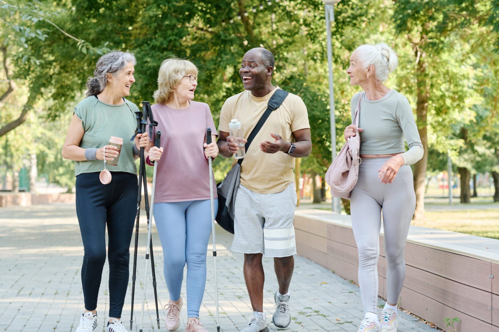 Group of people walking and talking outdoors.