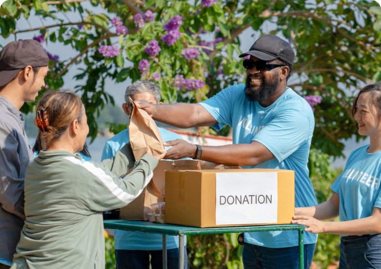 Group distributing donations at outdoor event.