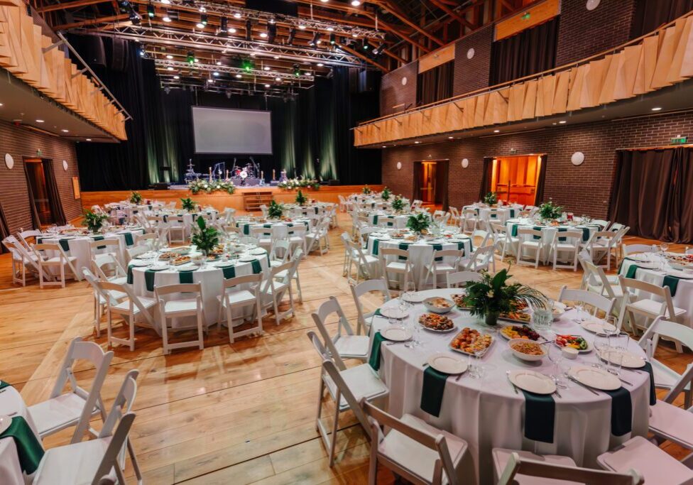 Banquet hall with round dining tables set.